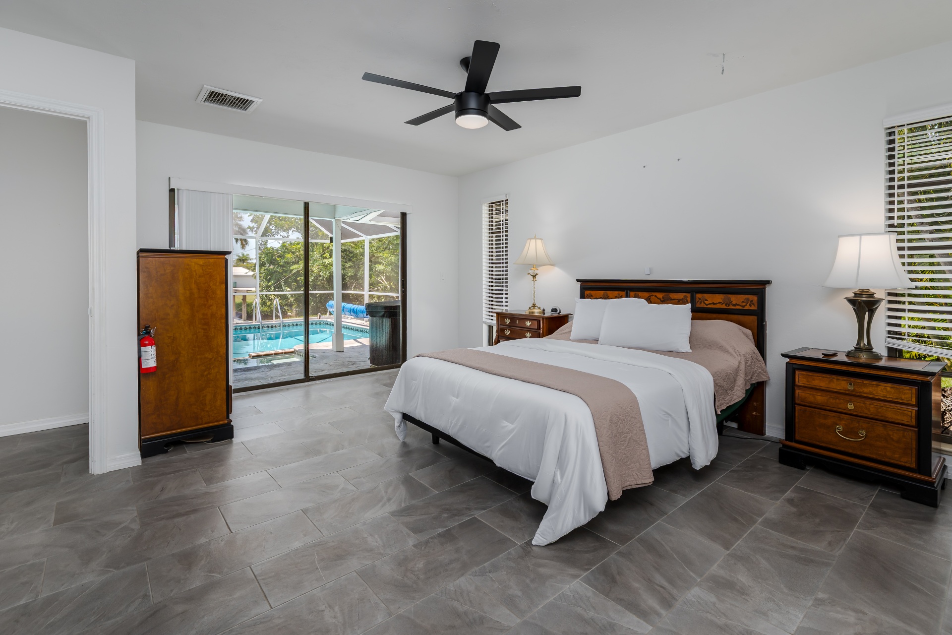 Primary bedroom with sliding glass doors to the pool