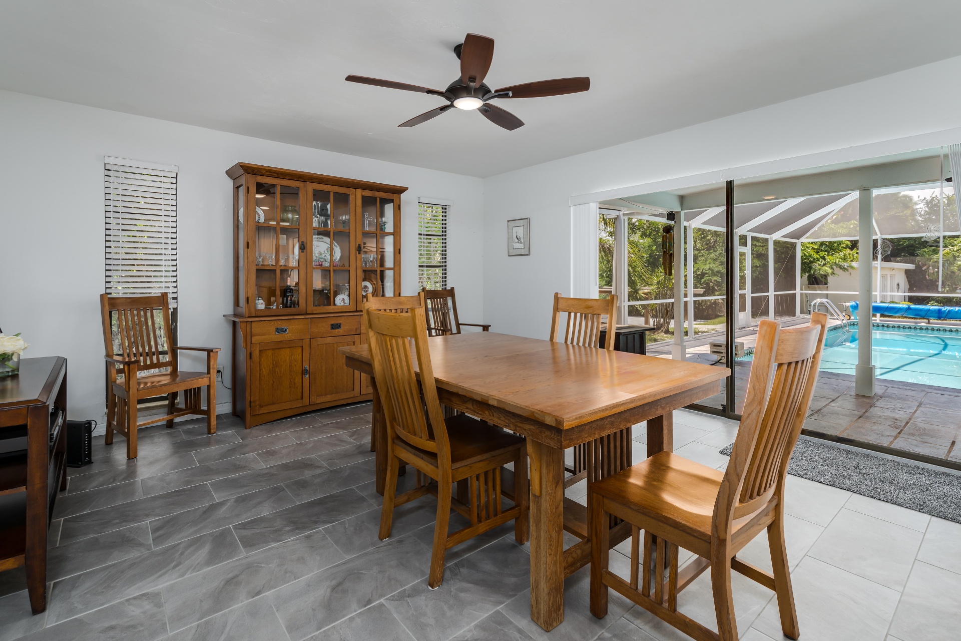 Dining area with pool views through sliding glass doors